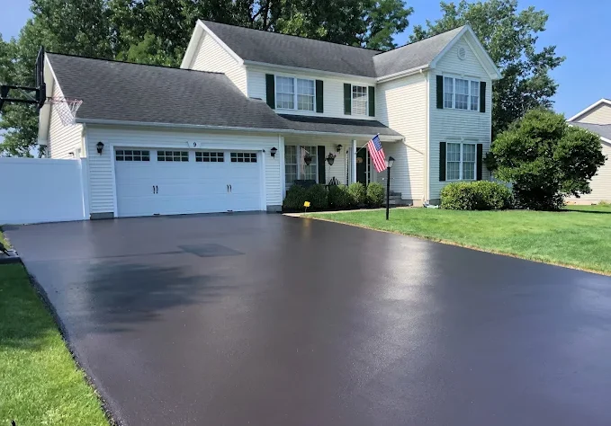 white house with fresh asphalt driveway